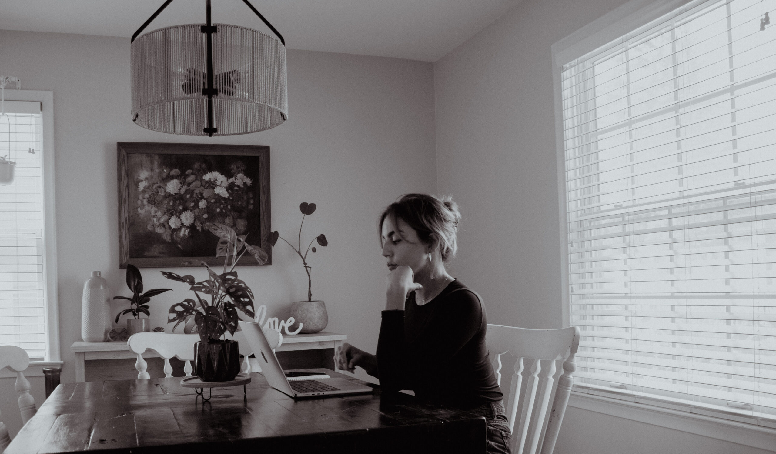 Milcia Collado working on a laptop at her dining table during the early days of building Avivar Co.